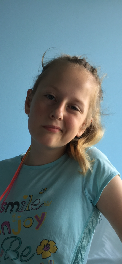 The author’s daughter smiling after her recovery